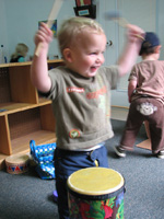 Child plays drum set